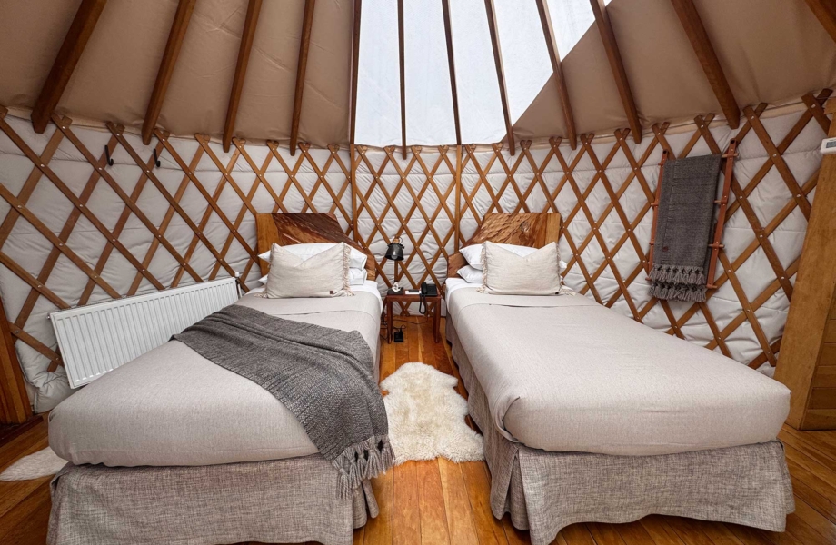 Interior of a private suite at Patagonia Camp featuring warm, natural design elements.