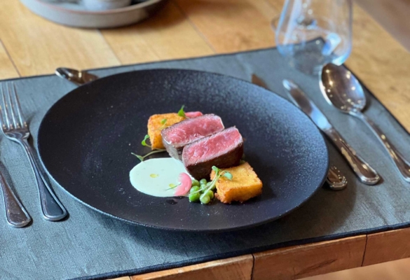 Plated red-meat entrée with regional sides