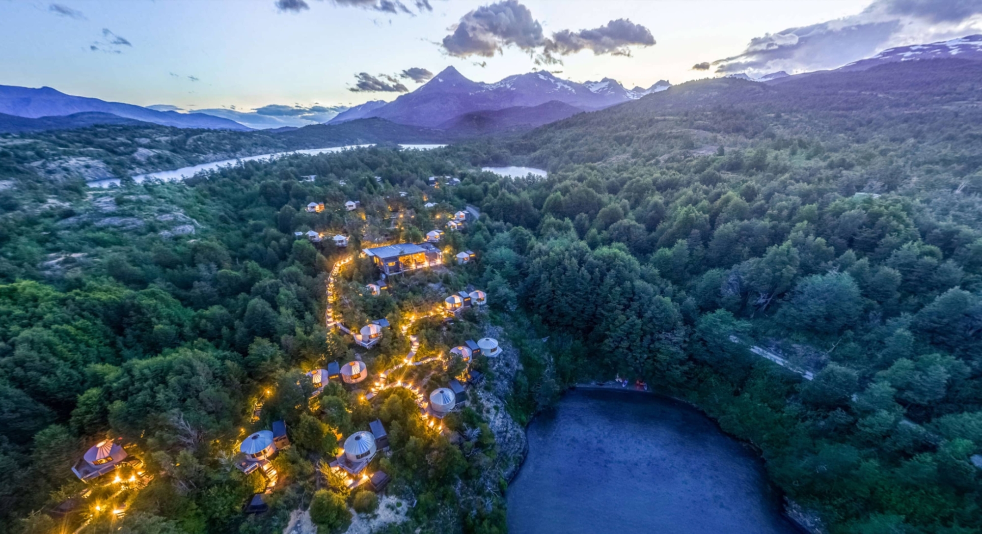 Night view of Patagonia Camp with soft lighting and Patagonian scenery.